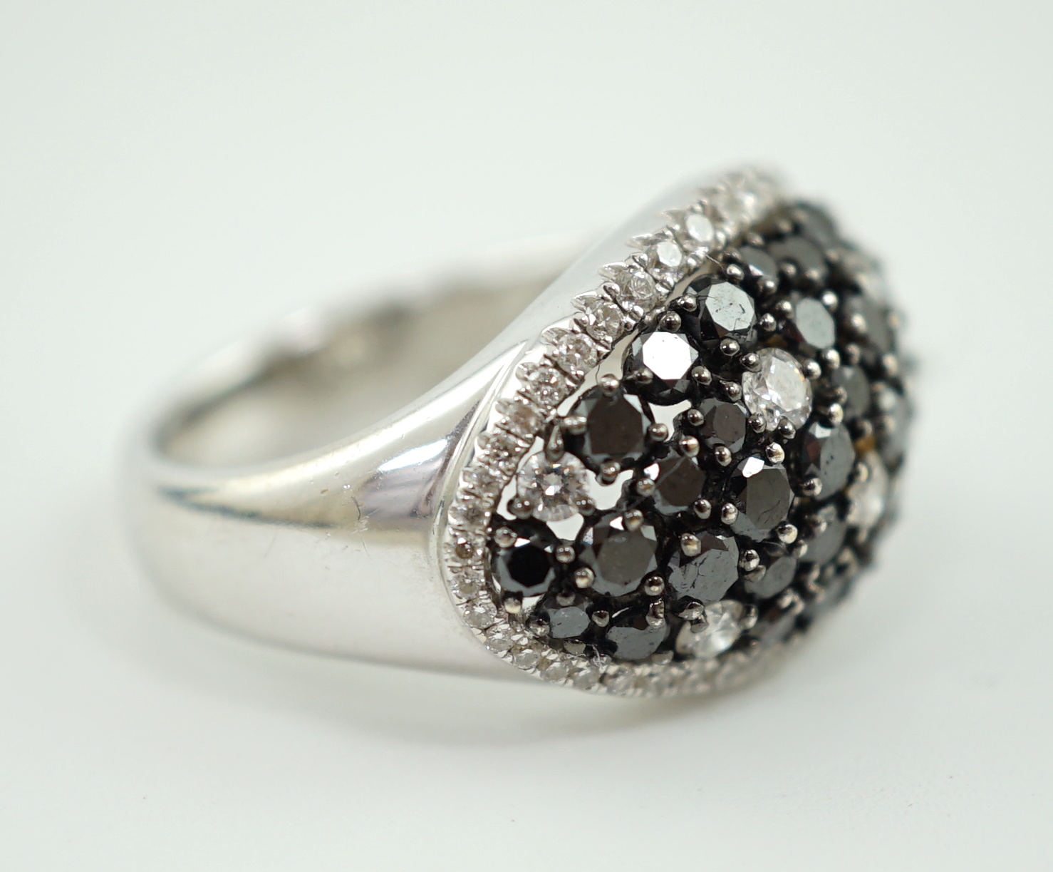 A modern pair of 750 white gold and two colour diamond cluster dress ring